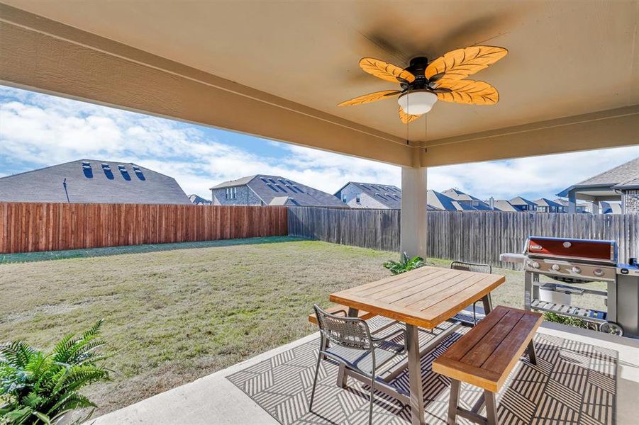 View of patio with ceiling fan and a grill