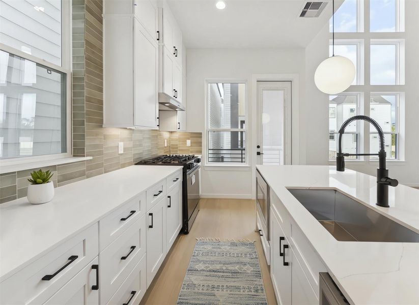 Another shot capturing how the space opens effortlessly to the living area and its impressive 20-ft ceilings, with the balcony door adding even more light and openness. *Virtually staged*