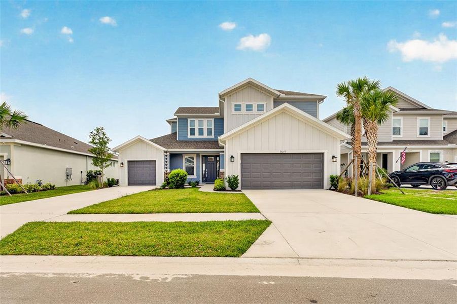 Front exterior of a new home in River Landing, Wesley Chapel, FL, highlighting curb appeal (Image 25). Front exterior of a new home in River Landing, Wesley Chapel, FL, highlighting curb appeal (Image 25).