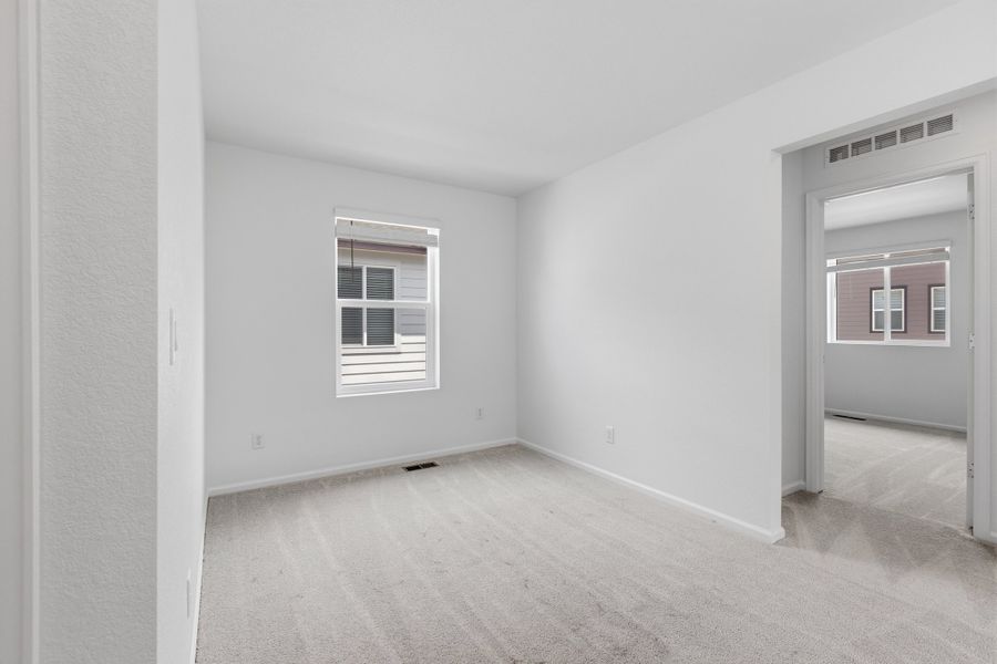 Spacious, unfurnished interior of a new home in Woodrose at Painted Prairie, Aurora (Image 13).