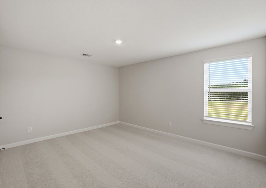 Secondary bedroom featuring a window and carpet flooring.