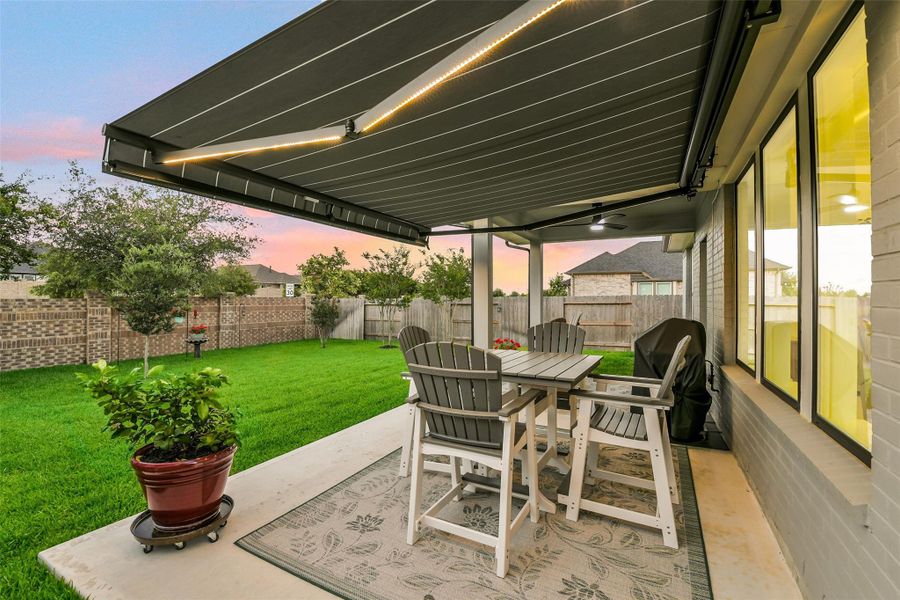 The extended patio has a retractable awning with lighting! No detail is left out in this beautiful outdoor living space!