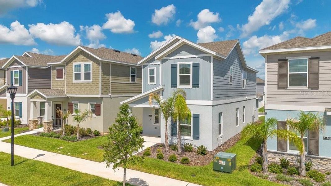 Front exterior of a new home in Wellness Ridge, Clermont, FL, highlighting curb appeal (Image 24).