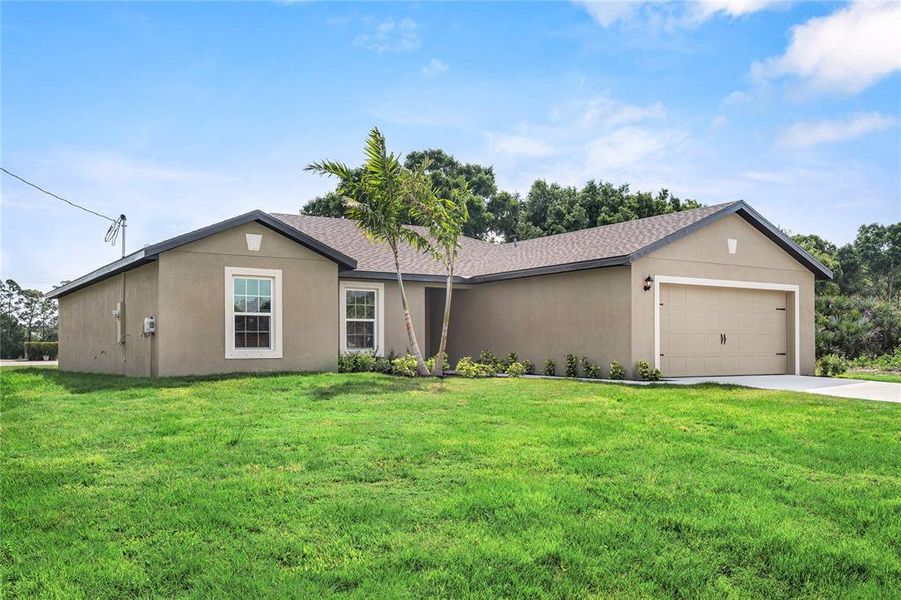 Front exterior of a new home in , Port Charlotte, FL, highlighting curb appeal (Image 1).