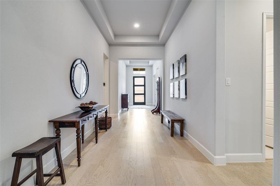 Wide, spacious and grand hallway. The details in the tray ceiling and the lighter floors make this long hallway bright, open and welcoming. Wide, spacious and grand hallway. The details in the tray ceiling and the lighter floors make this long hallway bright, open and welcoming.