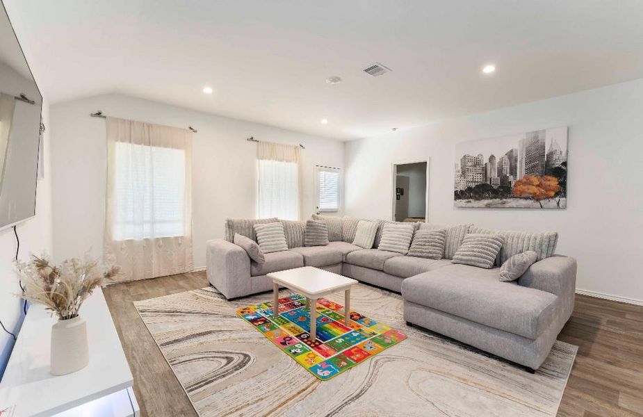 This spacious living room features plenty of natural light from two windows creating a welcoming space, perfect for relaxation and entertaining. This spacious living room features plenty of natural light from two windows creating a welcoming space, perfect for relaxation and entertaining.