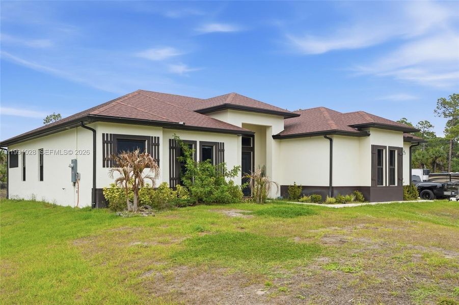 Front exterior of a new home in , Naples, FL, highlighting curb appeal (Image 27).