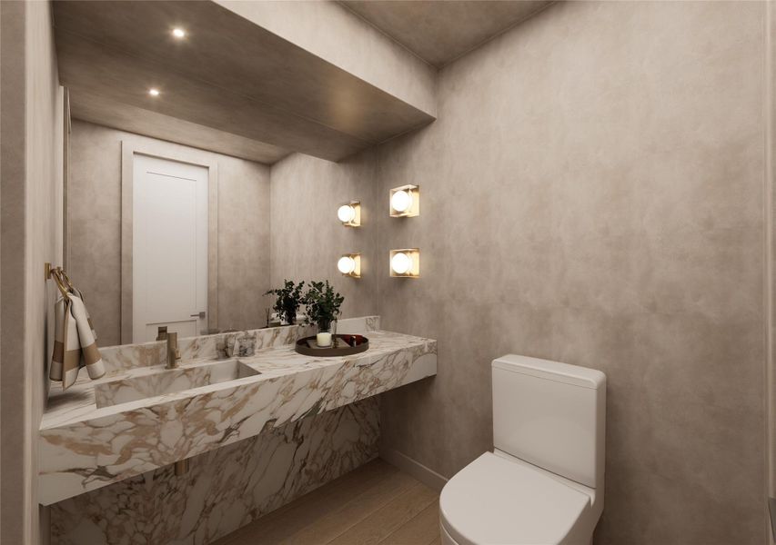 A jewel-box powder bath that makes a lasting impression, showcasing a striking waterfall marble vanity with dramatic veining and warm brass fixtures. Sculptural wall sconces cast a soft glow, creating an intimate space where every detail feels intentionally elevated. A jewel-box powder bath that makes a lasting impression, showcasing a striking waterfall marble vanity with dramatic veining and warm brass fixtures. Sculptural wall sconces cast a soft glow, creating an intimate space where every detail feels intentionally elevated.