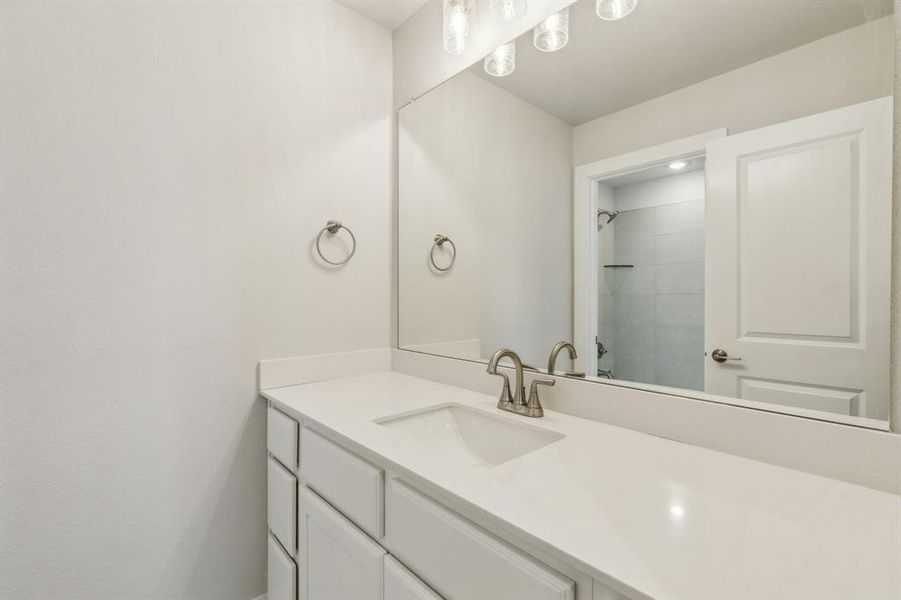 Bathroom with vanity and a tile shower