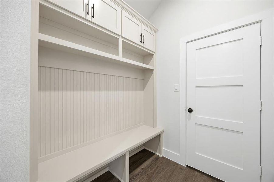 Built-in white cabinetry with beadboard backing, open shelving, and integrated bench seating