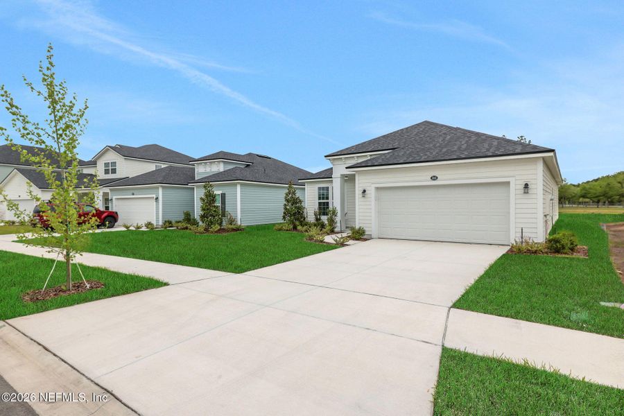 Front exterior of a new home in Amberly, Green Cove Springs, FL, highlighting curb appeal (Image 19). Front exterior of a new home in Amberly, Green Cove Springs, FL, highlighting curb appeal (Image 19).