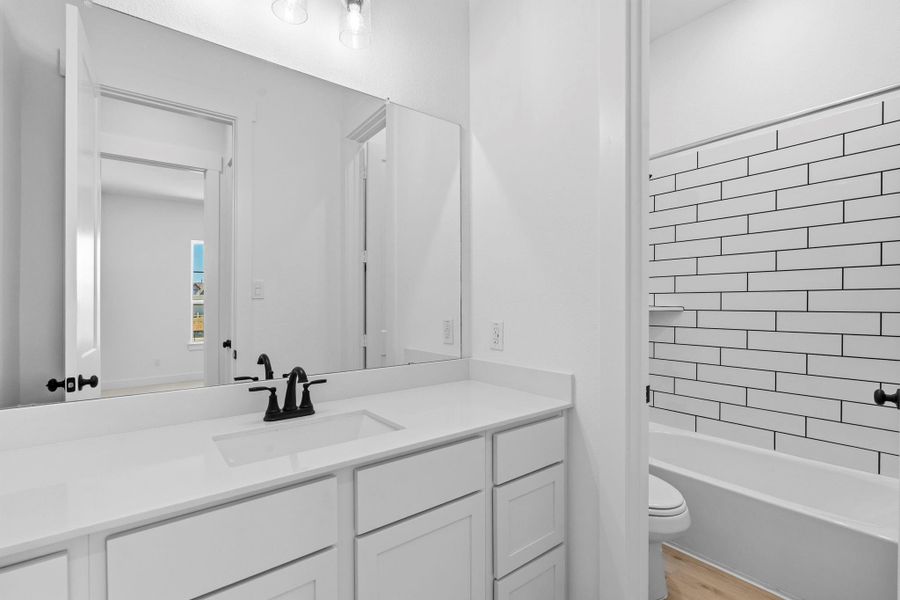 Finishes like luxurious ceramic tile flooring, brushed nickel or matte black fixtures, and soft, neutral tones tie the room together, creating a spa-like retreat within the home.