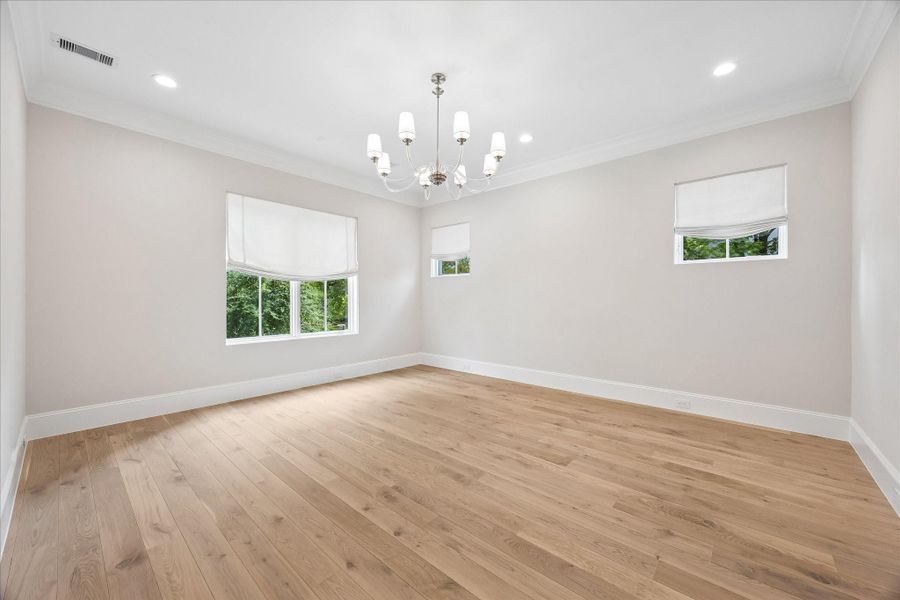 The Primary Suite is adorned with 10-foot ceilings and a designer light fixture. Exquisite Legno BastoneEuropean White Oak wood floors continue in this space adding to itsoverall elegance and charm.