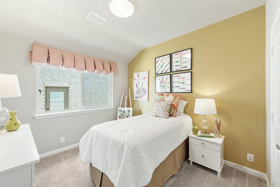 Children's bedroom with yellow accent wall, twin bed, white nightstand, and art-themed wall decor Children's bedroom with yellow accent wall, twin bed, white nightstand, and art-themed wall decor