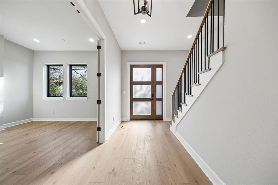 Foyer with light wood-style floors and recessed lighting Foyer with light wood-style floors and recessed lighting