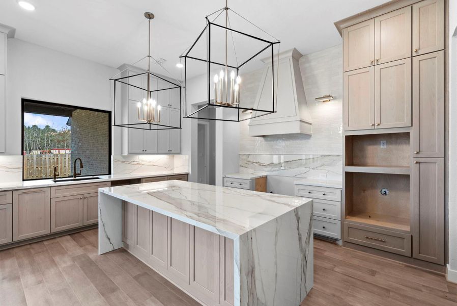 Kitchen with large window above the sink. Appliances will be installed upon closing.