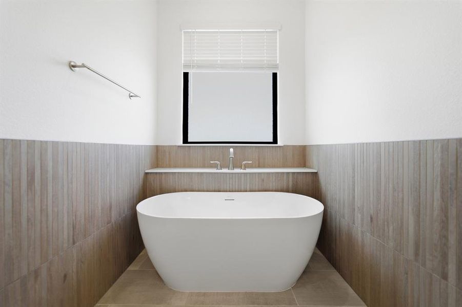 Freestanding soaking tub set against wood-finish tile wainscoting Freestanding soaking tub set against wood-finish tile wainscoting
