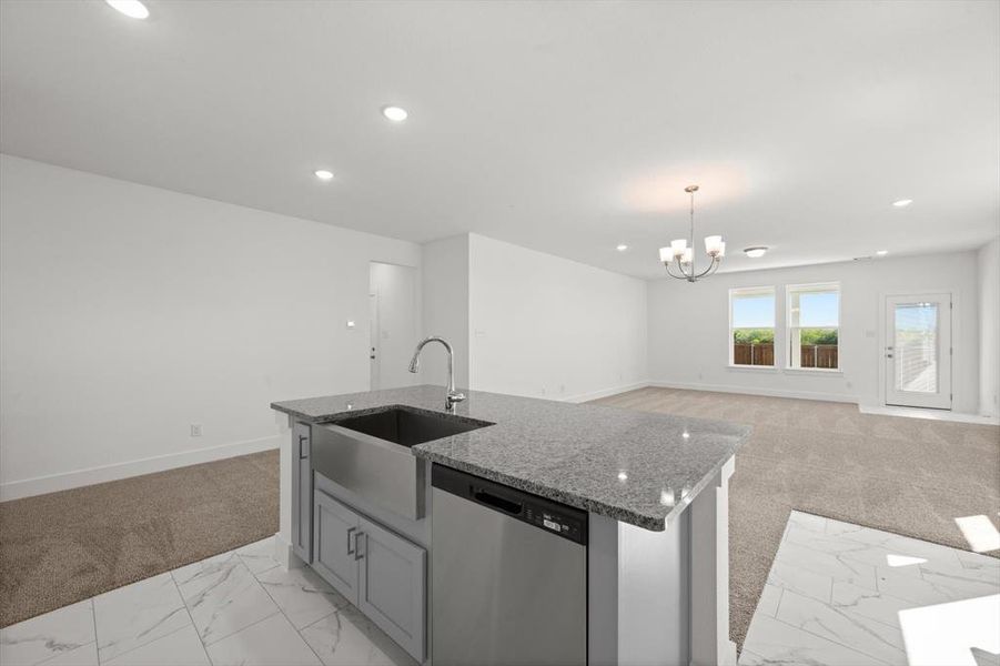 Kitchen with island breakfast bar, granite countertops, and tile floors