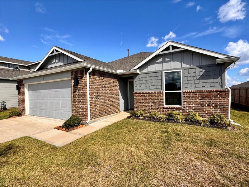 Front exterior of a new home in Santa Fe, Cleveland, TX, highlighting curb appeal (Image 2).
