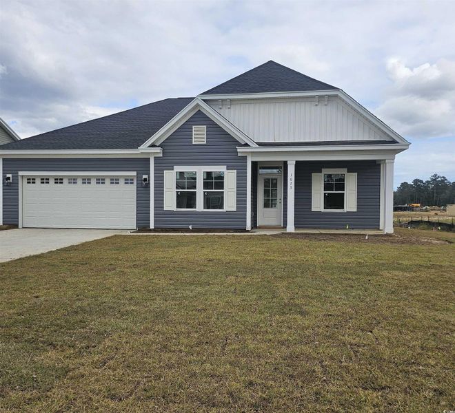 View of front of home featuring a front lawn, concrete driveway, a shingled roof, covered porch, and an attached garage View of front of home featuring a front lawn, concrete driveway, a shingled roof, covered porch, and an attached garage