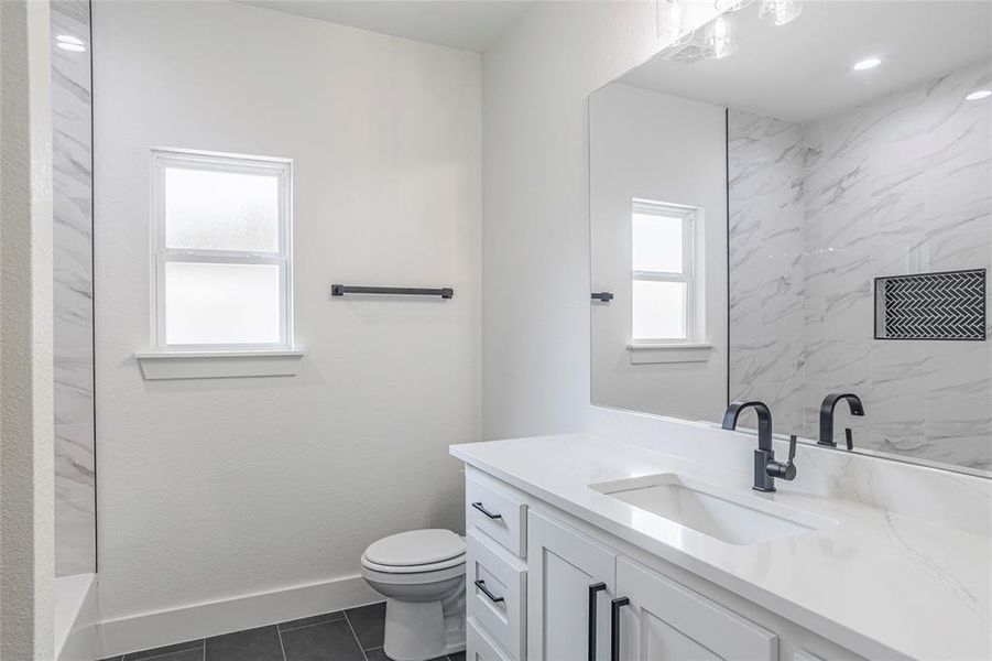 Bathroom with vanity, tile patterned flooring, and toilet