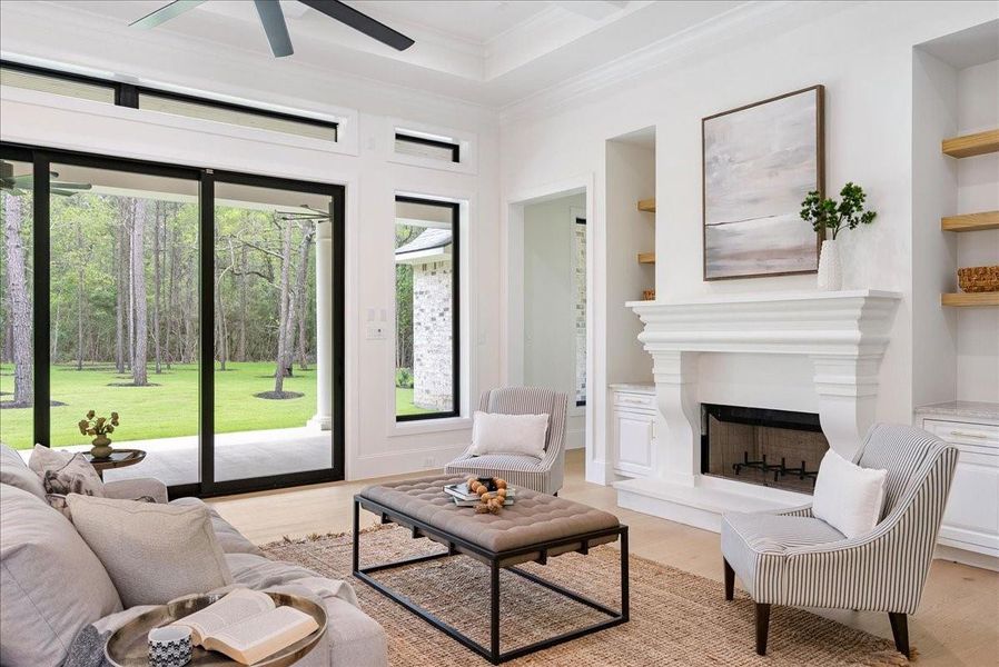 Expansive rear doors dissolve the boundary between indoors and out, creating a seamless connection to the covered outdoor living spaces beyond.