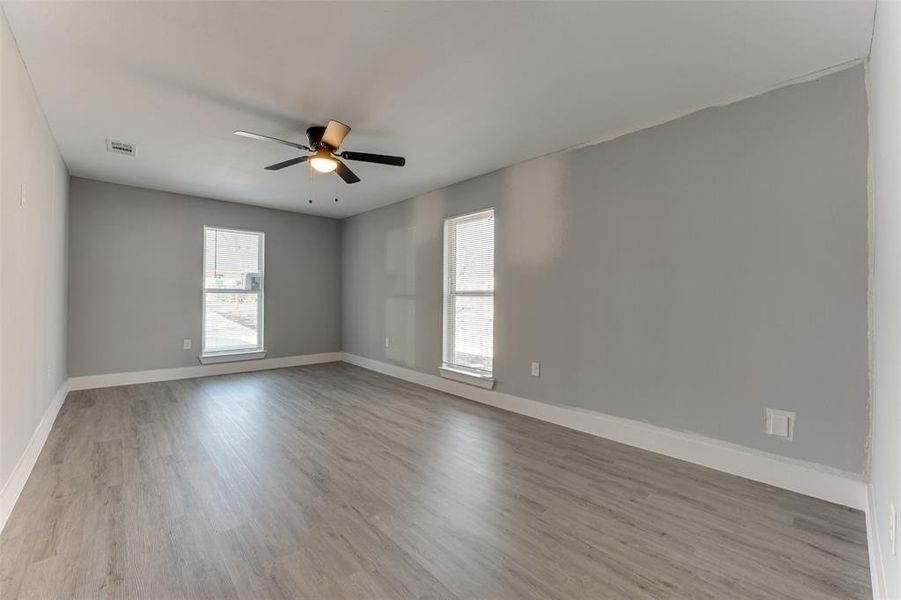 Unfurnished room featuring ceiling fan and light wood-type flooring