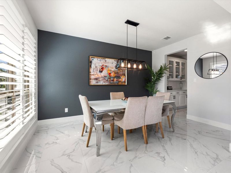 Across the foyer, natural light filters into the formal dining room that's connected to the kitchen thru the butler's pantry.