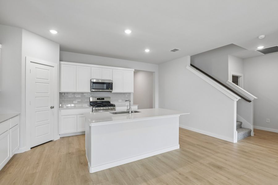 Kitchen in the Holden home plan by Trophy Signature Homes