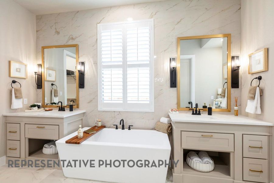 Bathroom featuring a soaking tub, marble finish floors, two vanities, and tile walls Bathroom featuring a soaking tub, marble finish floors, two vanities, and tile walls