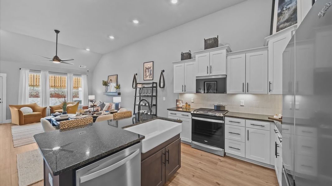 Tasteful kitchen with a streamlined island and modern finishes in a first-class DRB Homes design Tasteful kitchen with a streamlined island and modern finishes in a first-class DRB Homes design