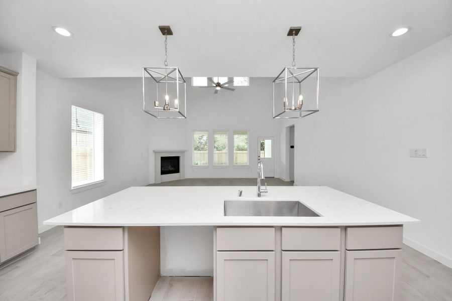 All of this overlooks your expansive family room, creating a perfect space for culinary delights and family gatherings. Sample photo of completed home with similar floor plan. Actual colors and selections may vary.