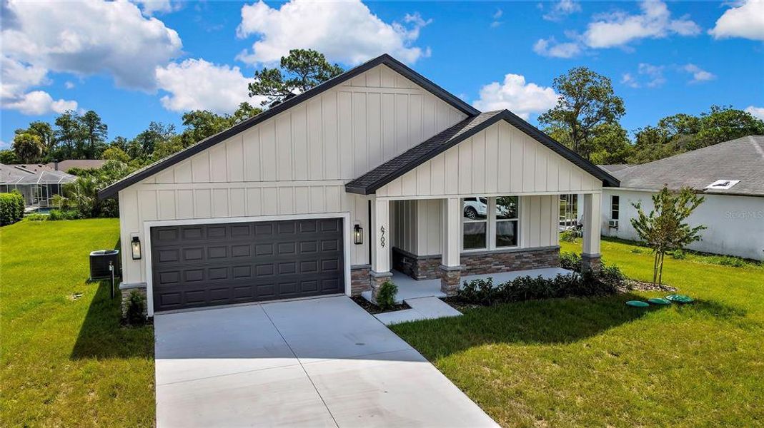 Front exterior of a new home in , Spring Hill, FL, highlighting curb appeal (Image 27).