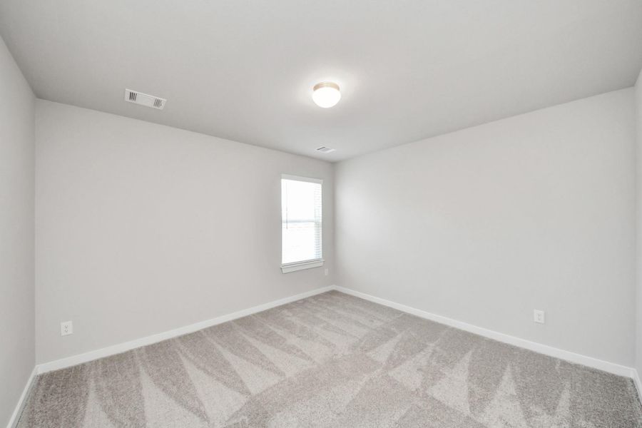 Generously sized secondary bedrooms featuring spacious closets, soft and inviting carpeting underfoot, large windows allowing plenty of natural light. Sample photo of completed home with similar plan. Actual colors and selections may vary. Call for more info.