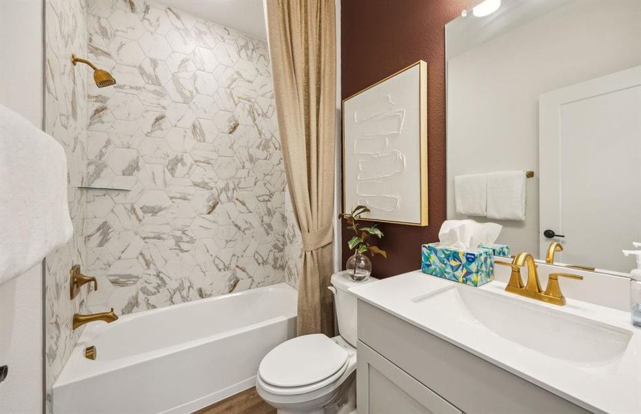 Secondary bathroom featuring modern upgrades and finishes *Model representation
