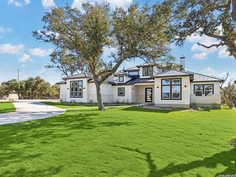 Front exterior of a new home in , Bulverde, TX, highlighting curb appeal (Image 24).