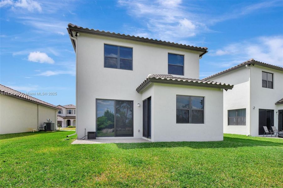 Front exterior of a new home in , Ave Maria, FL, highlighting curb appeal (Image 1).