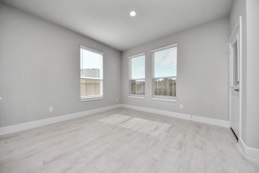 Enjoy breakfast with ease in the connected and cozy breakfast area, seamlessly integrated with the kitchen for utmost convenience. Step through the back door for a breath of fresh air onto the covered patio, extending your living space to the outdoors.