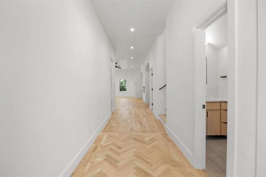 Upon entering the home, you're welcomed by an elegant, elongated foyer showcasing rich natural white oak hardwood flooring. A stunning herringbone inlay at the front entry creates a sophisticated first impression, setting the tone for the home's exceptional craftsmanship and timeless design. Upon entering the home, you're welcomed by an elegant, elongated foyer showcasing rich natural white oak hardwood flooring. A stunning herringbone inlay at the front entry creates a sophisticated first impression, setting the tone for the home's exceptional craftsmanship and timeless design.