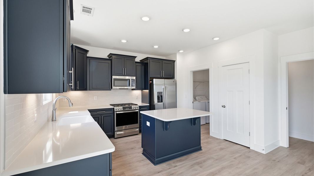 Memorable meals begin in this vibrant kitchen with a thoughtfully designed island located at Iris Meadows