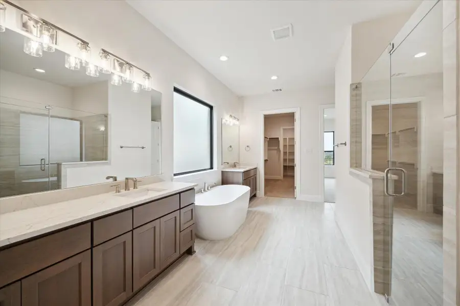 Primary Bath with custom-built cabinetry, designer selections, deep soaking Bathtub, and walk-in Shower. Primary Bath with custom-built cabinetry, designer selections, deep soaking Bathtub, and walk-in Shower.