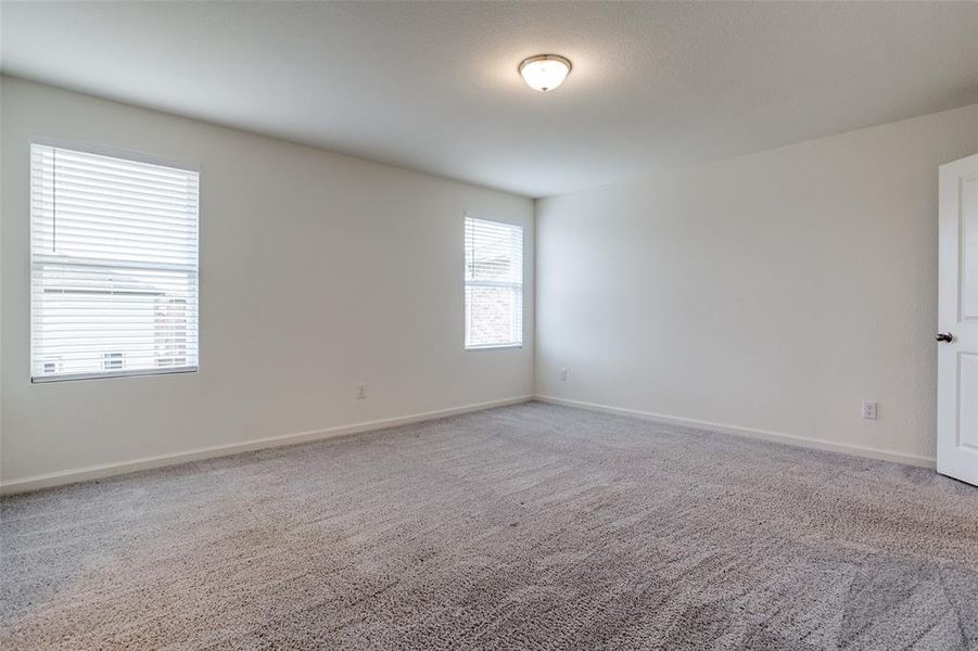 Spare room featuring a healthy amount of sunlight and carpet