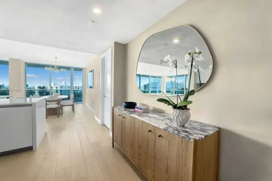 Light-toned wood-finish flooring, floor-to-ceiling windows, and recessed lighting Light-toned wood-finish flooring, floor-to-ceiling windows, and recessed lighting