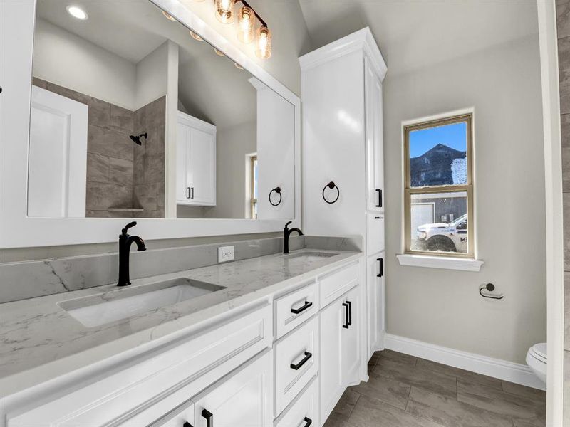 Bathroom with vanity, toilet, and walk in shower