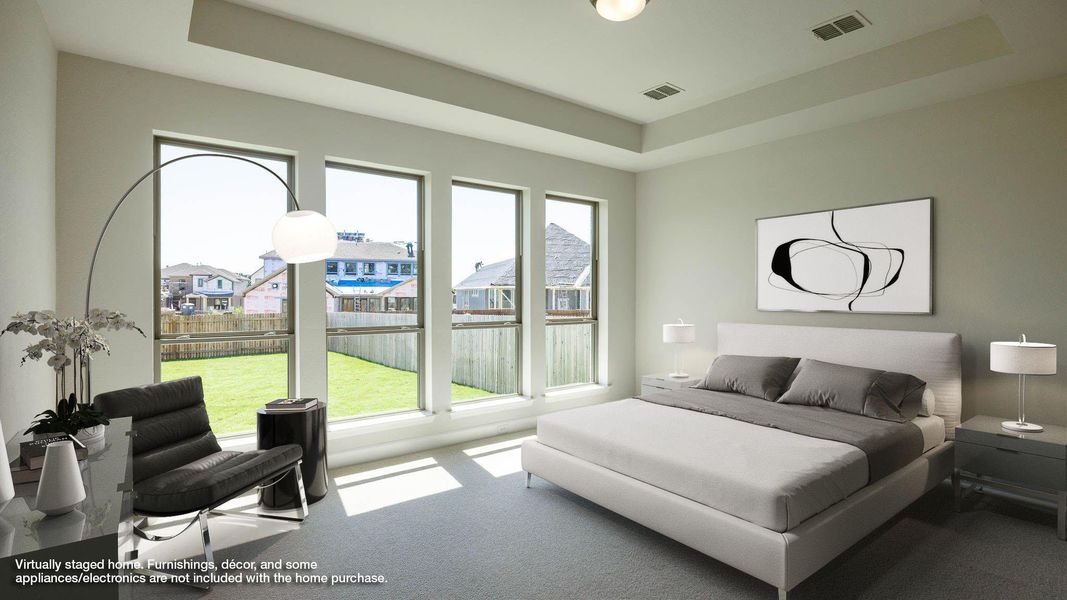 Carpeted bedroom featuring a tray ceiling and a residential view