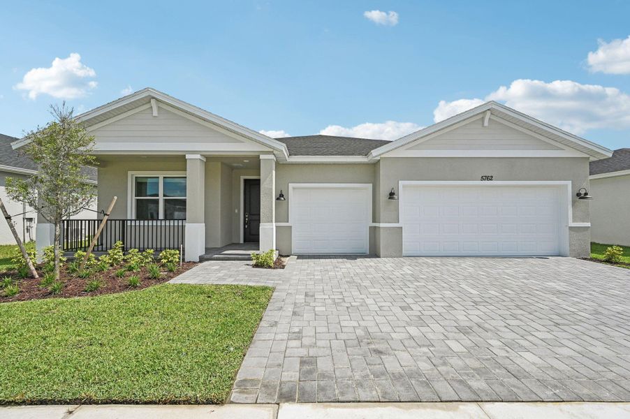 Front exterior of a new home in Hampton Park - Signature Series, Vero Beach, FL, highlighting curb appeal (Image 22). Front exterior of a new home in Hampton Park - Signature Series, Vero Beach, FL, highlighting curb appeal (Image 22).