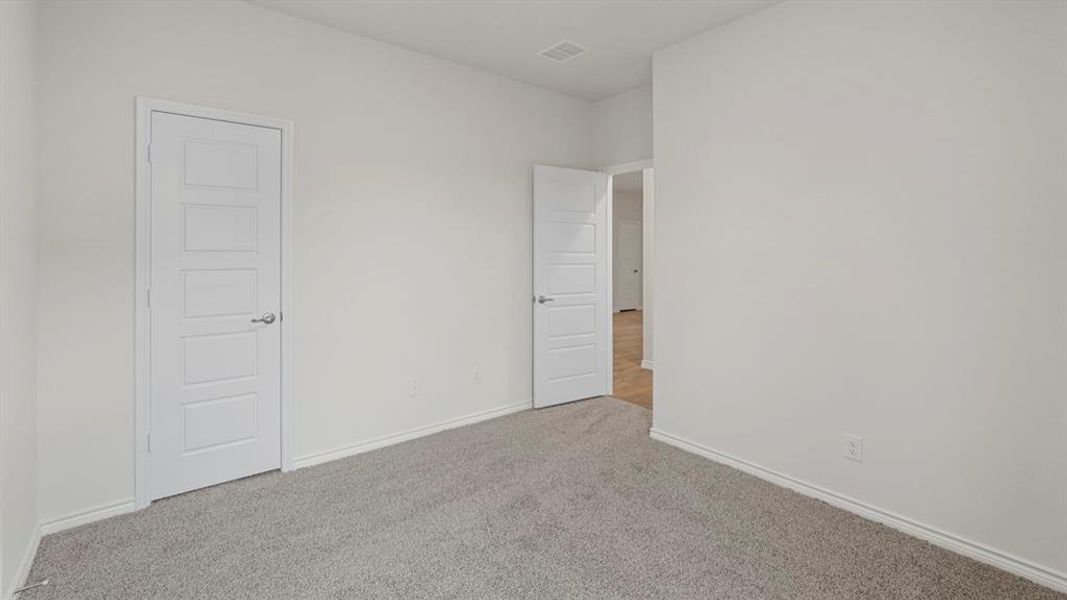 Unfurnished bedroom with carpet floors and baseboards Unfurnished bedroom with carpet floors and baseboards