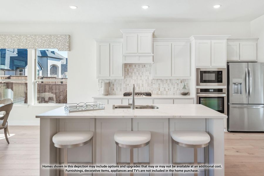 Kitchen with white cabinets, tile backsplash, large island with seating, and stainless steel appliances Kitchen with white cabinets, tile backsplash, large island with seating, and stainless steel appliances