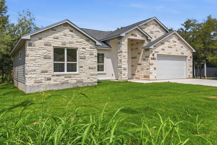 A newly constructed residence features an attached garage and a neatly maintained yard. A newly constructed residence features an attached garage and a neatly maintained yard.