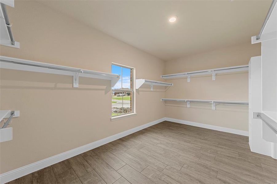 Spacious closet with wood finished floors